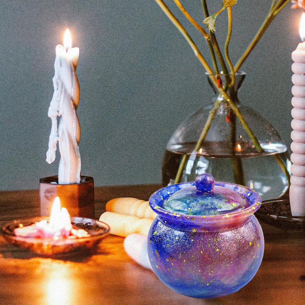 Decorative candle holder with candles and a glass vase on a wooden surface.